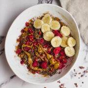 Healthy porridge with rasberries, almond butter, and other high protein toppings.