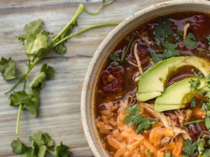 bowl of instant pot made chicken tortilla soup with cilantro on table