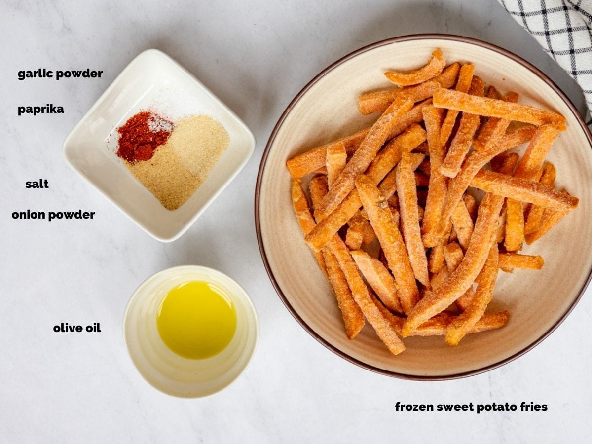 Ingredients needed to make frozen airy fryer sweet potato fries. On a white countertop with a checkered dish cloth. 