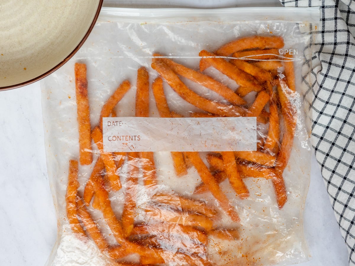 Frozen sweet potato fries in a ziploc bag with olive oil and spices.